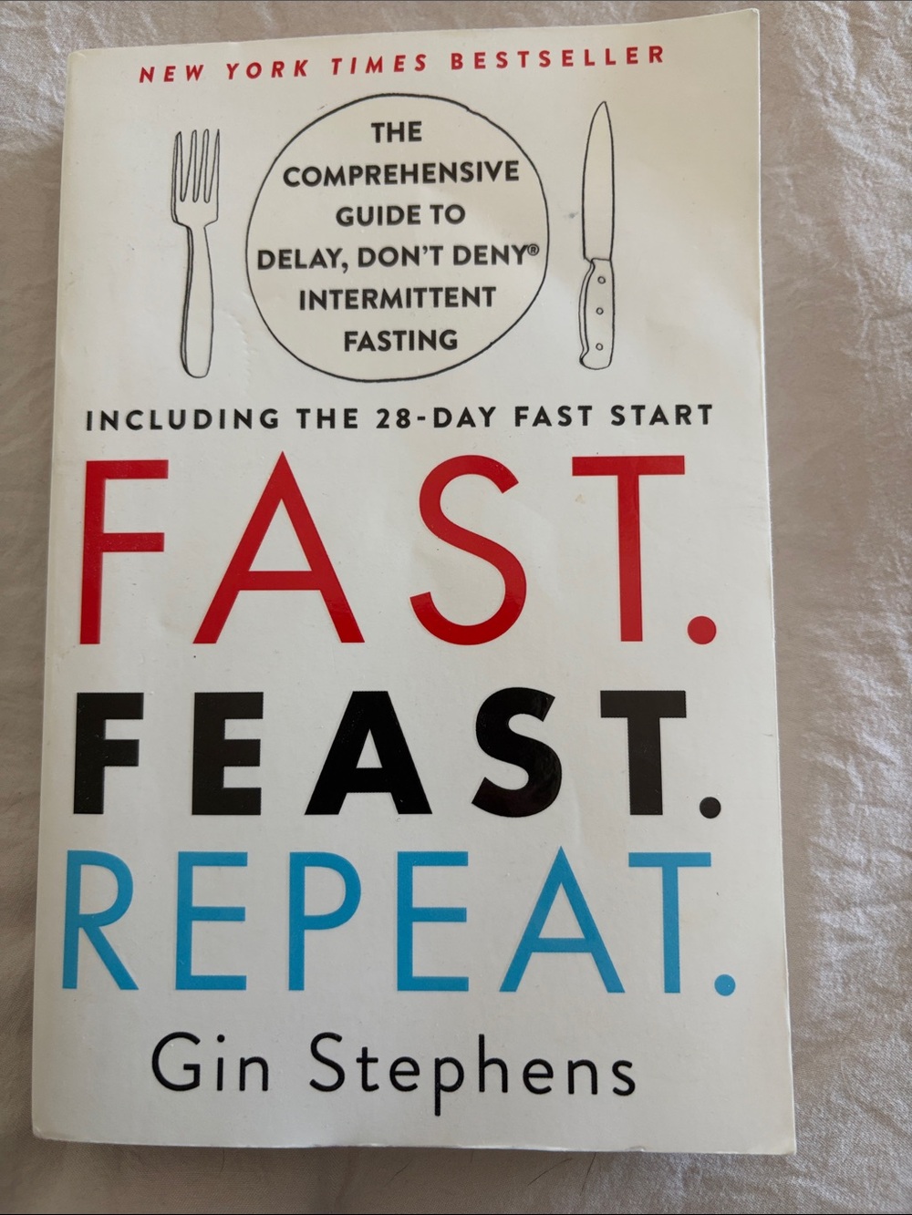 Fast. Feast. Repeat. by Gin Stephens - White Cover with Red, Black, Blue Text
